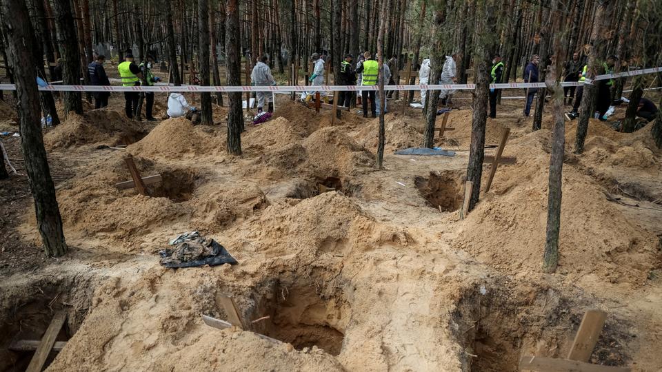 Residents of Iseum rush to look for the bodies of relatives in the cemetery.  Kiev says there is evidence of Russian torture of civilians